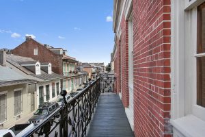 Apartments For Rent In New Orleans, LA - The Academy - Balcony With Ornate Wrought Iron Railing and View of Street